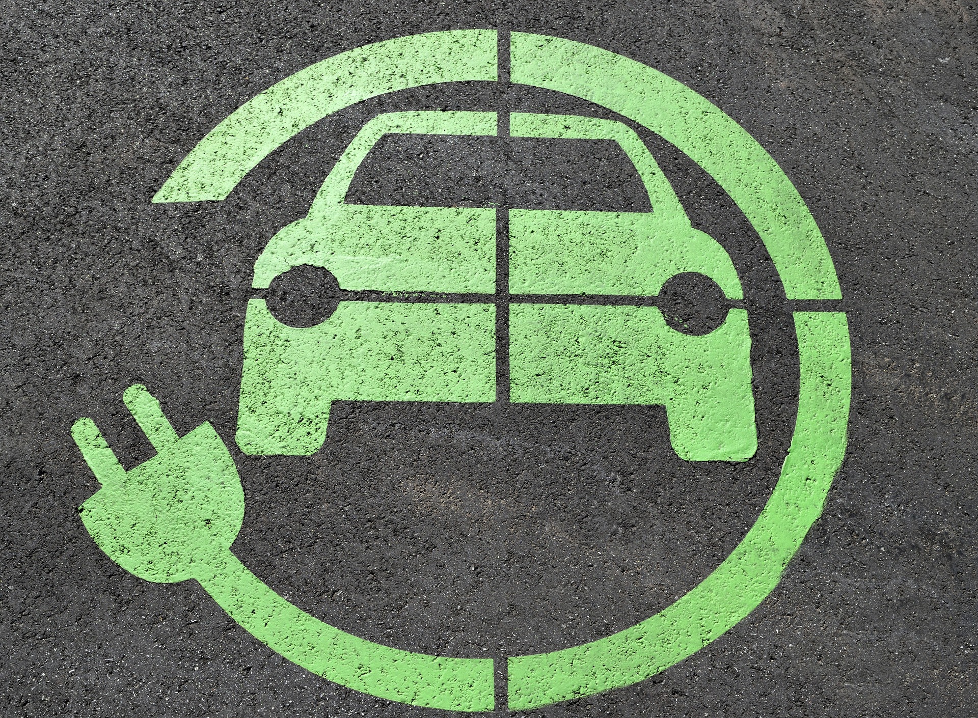 electric car charge symbol drawn on the road